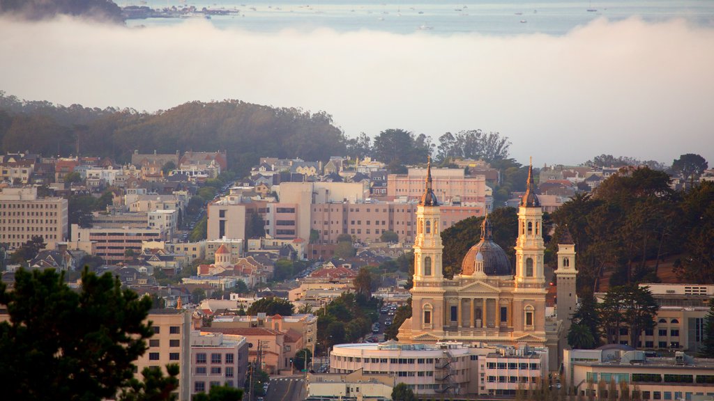 Twin Peaks featuring a city and mist or fog