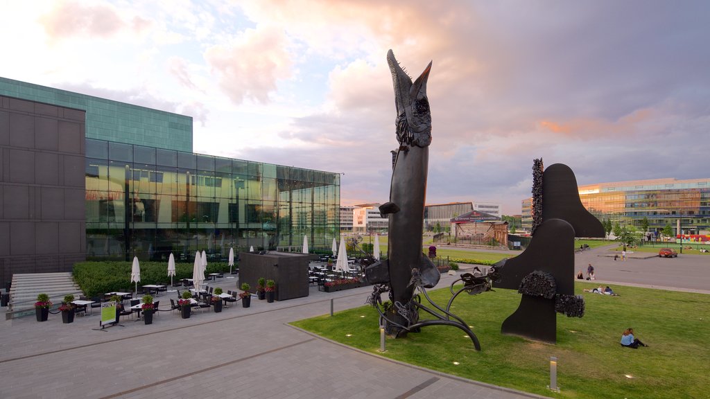 Helsinki Music Centre showing modern architecture, outdoor art and a sunset