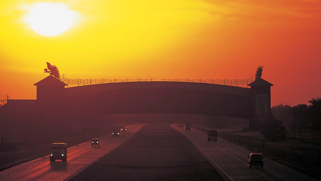 Great Platte River Road Archway welches beinhaltet Straßenszenen und Sonnenuntergang