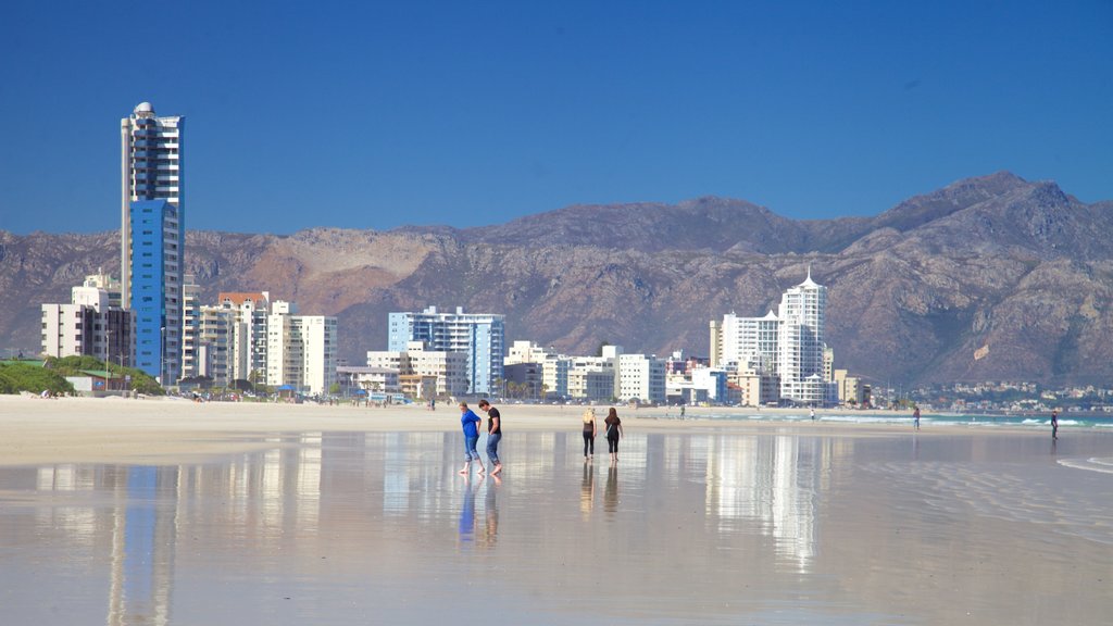 Strand which includes a city, landscape views and a beach