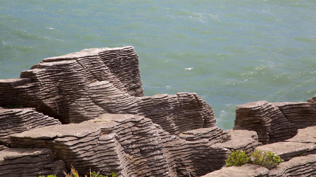 Pancake Rocks which includes rugged coastline and a bay or harbour