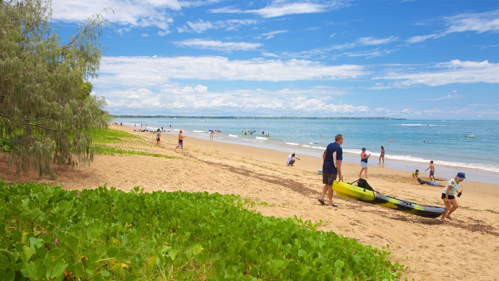 Esplanade featuring a beach and general coastal views as well as a small group of people