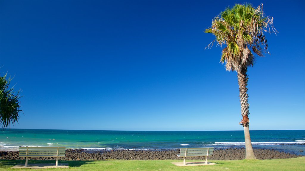 Bargara Beach which includes rocky coastline, a garden and general coastal views