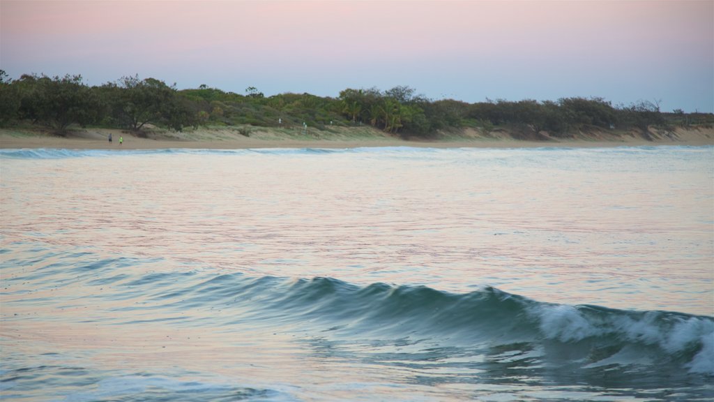 Agnes Water Beach featuring waves, a sunset and general coastal views