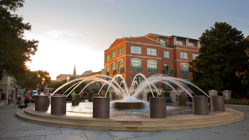 Charleston Waterfront Park featuring a fountain and a sunset