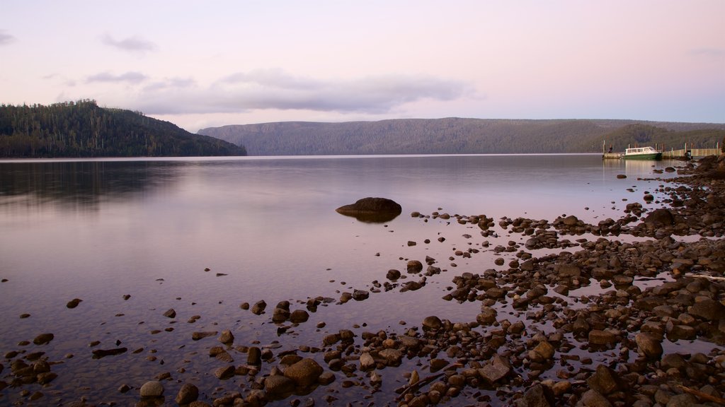 Lake St. Clair which includes a lake or waterhole and a sunset