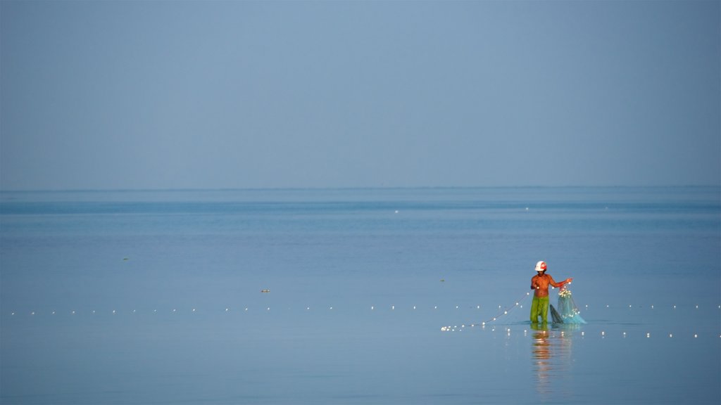 Nathon Pier featuring fishing and a bay or harbour as well as an individual male