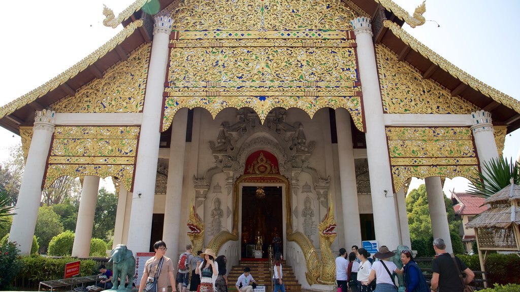 Wat Chedi Luang featuring a temple or place of worship as well as a small group of people