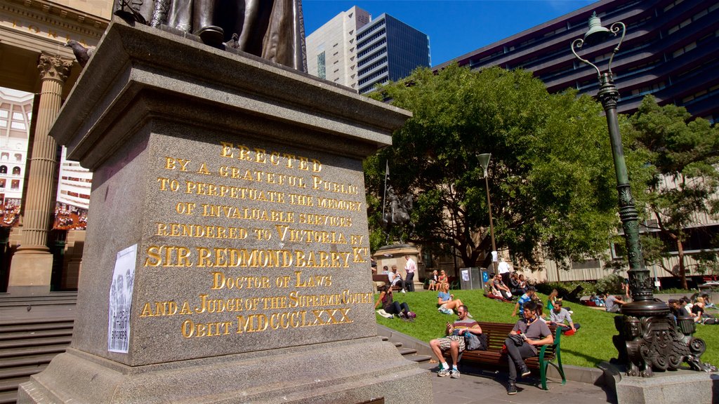 State Library of Victoria showing a statue or sculpture as well as a small group of people