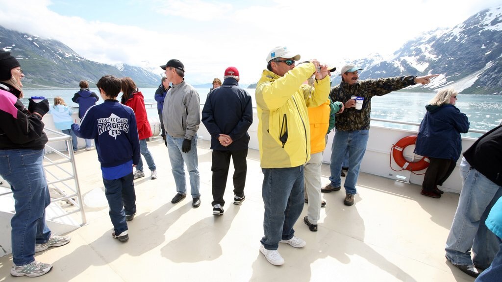 Glacier Bay National Park showing a bay or harbour and cruising as well as a small group of people