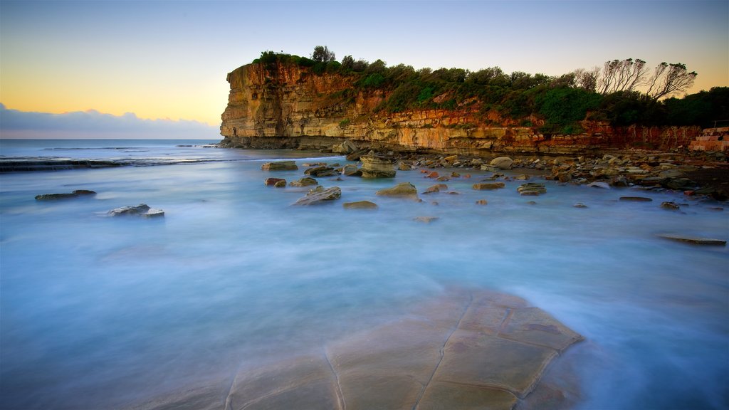 Terrigal montrant une baie ou un port, rochers au bord de la mer et un coucher de soleil