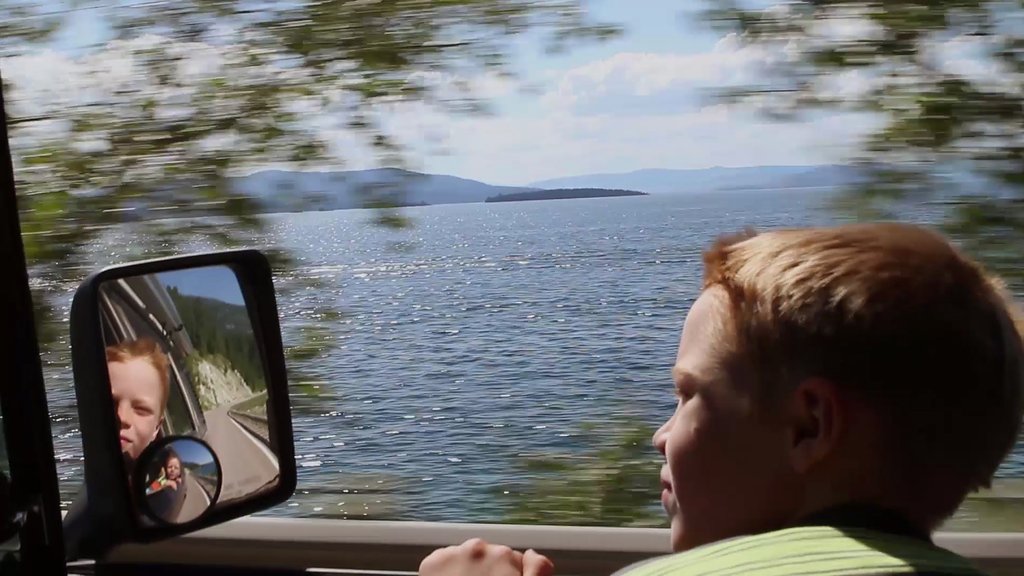 Flathead Lake featuring a lake or waterhole as well as an individual child