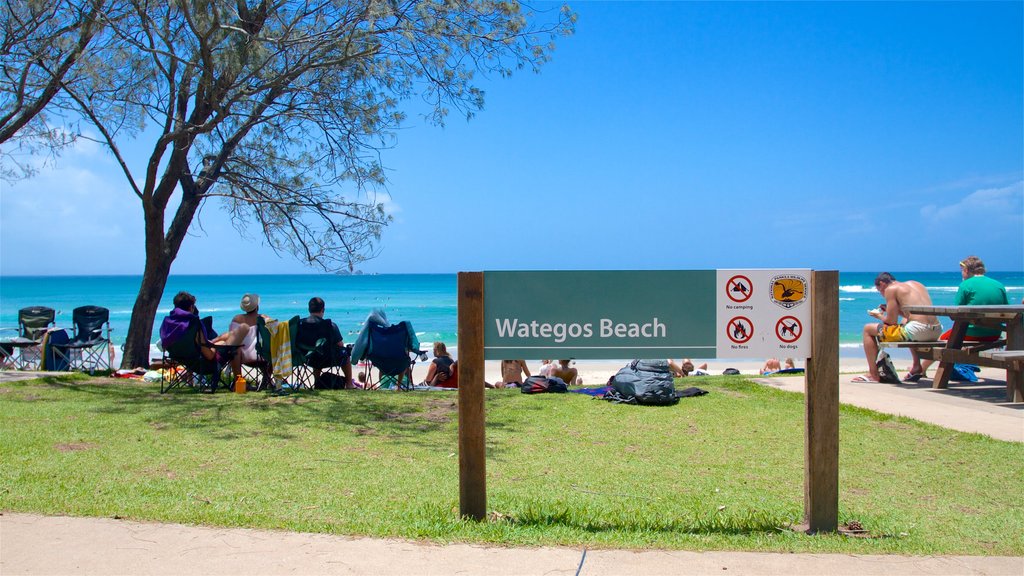 Wategos Beach which includes a beach and signage