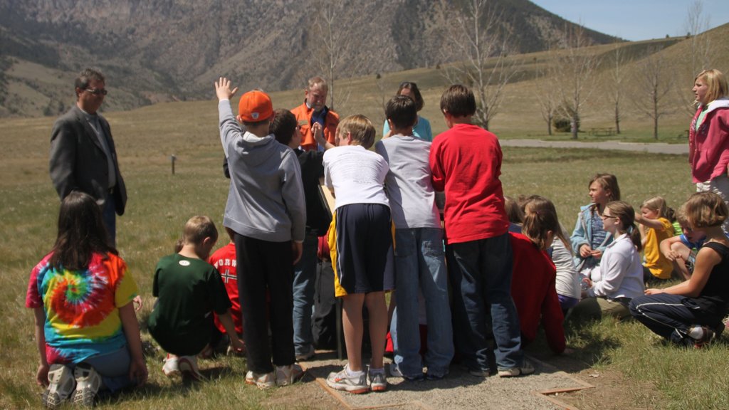 Butte which includes a garden as well as a large group of people