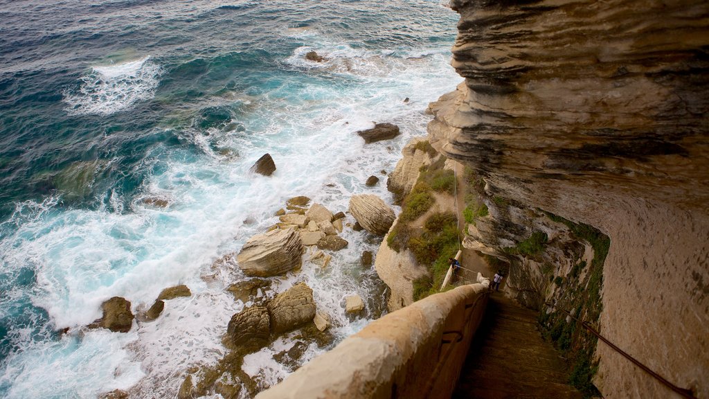 Escalier du Roi d\'Aragon which includes rugged coastline as well as a couple