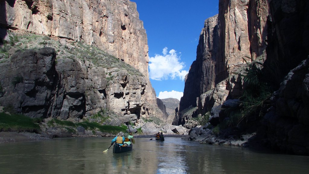 Big Bend National Park showing a gorge or canyon and kayaking or canoeing as well as a small group of people