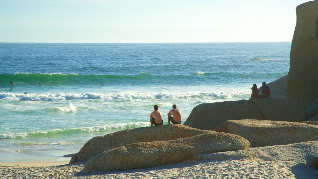 Camps Bay Beach which includes a sandy beach as well as a small group of people