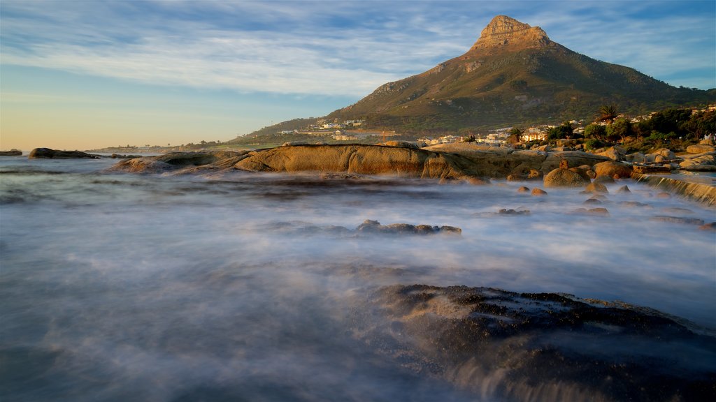 Camps Bay Beach featuring surf and rocky coastline