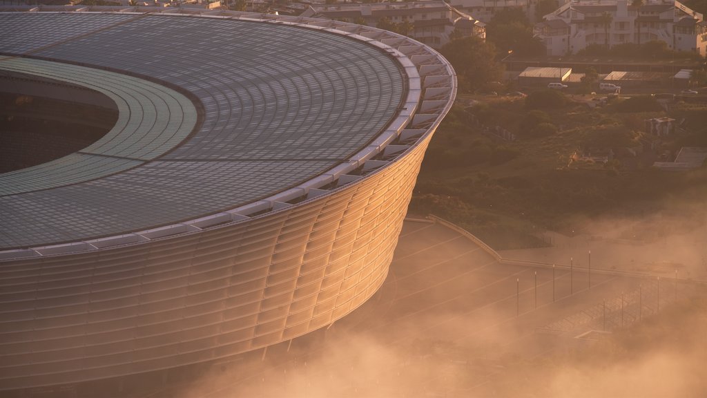 Cape Town Stadium featuring a city and a sunset