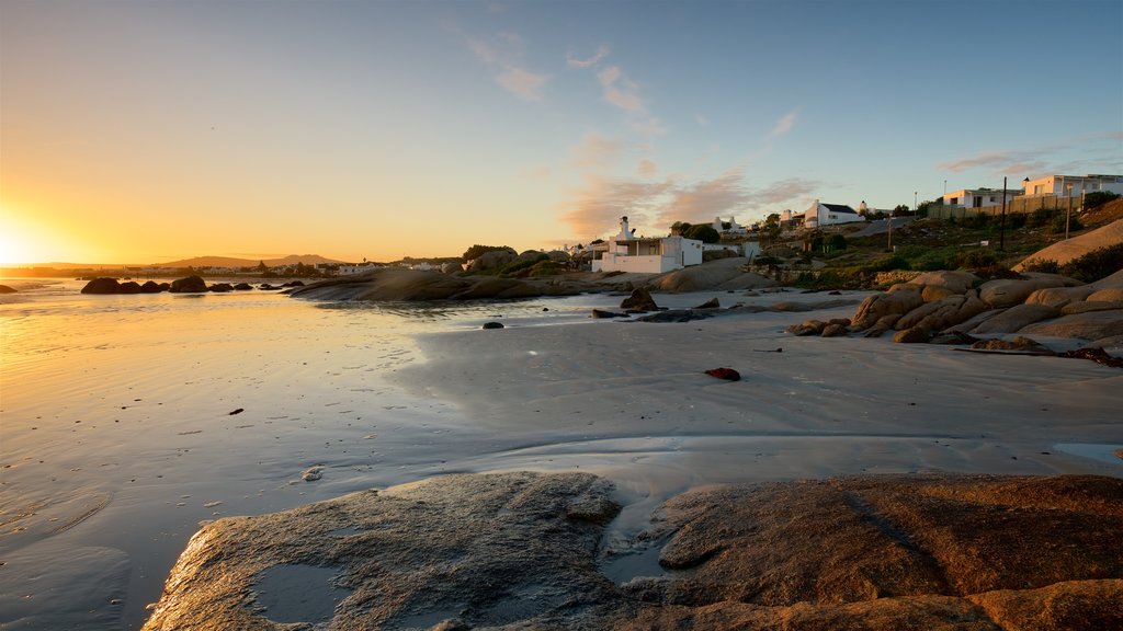 Paternoster Beach which includes a coastal town, a sunset and a beach