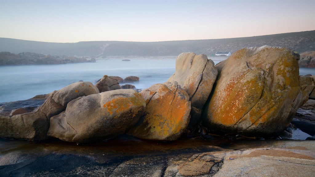 Cape Columbine Lighthouse which includes landscape views, rocky coastline and mist or fog