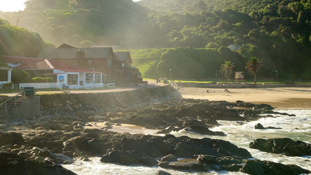 Victoria Bay Beach showing a sandy beach, a coastal town and rugged coastline