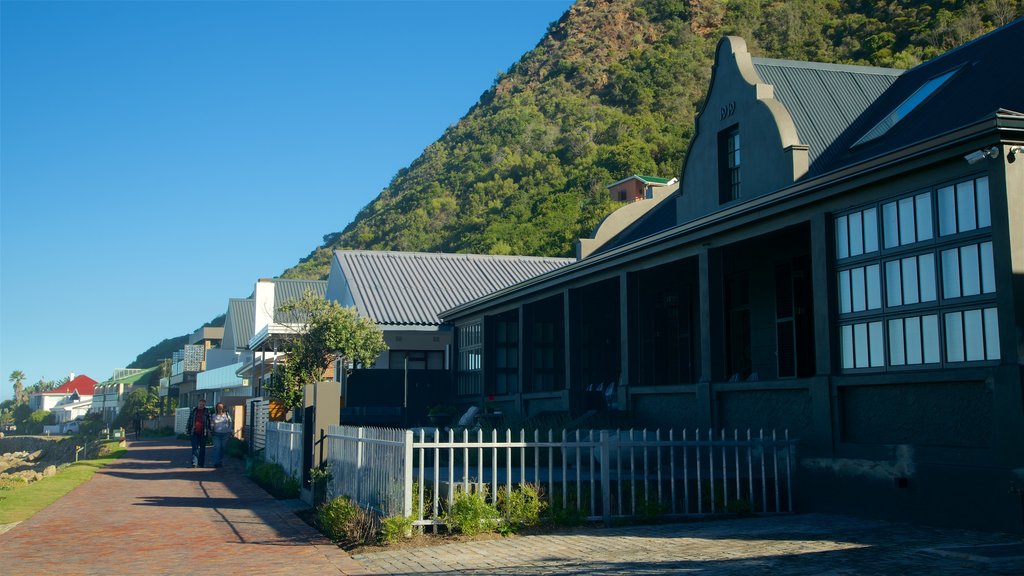 Victoria Bay Beach showing a coastal town and street scenes as well as an individual male