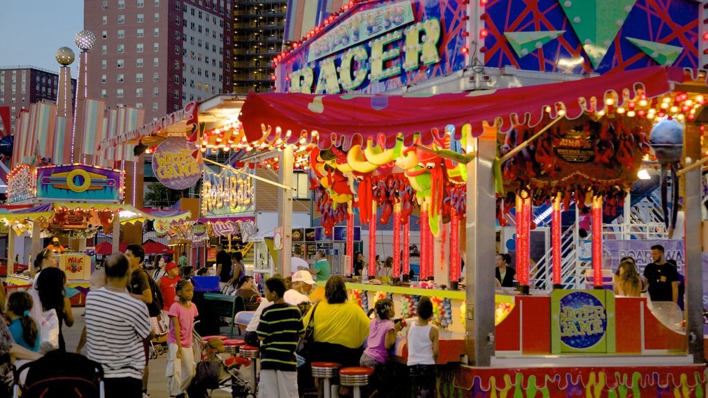 Coney Island showing a city, signage and rides