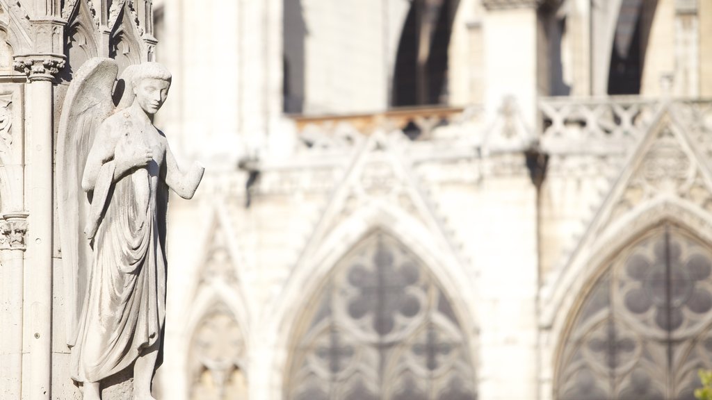 Notre Dame Cathedral showing heritage architecture, a statue or sculpture and a church or cathedral