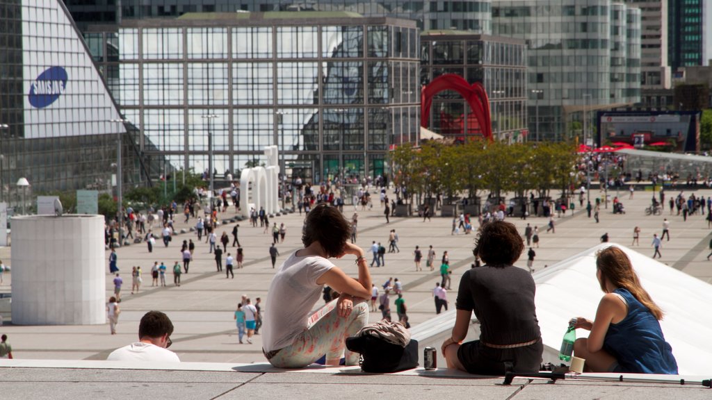 La Defense which includes a square or plaza and a city as well as a small group of people