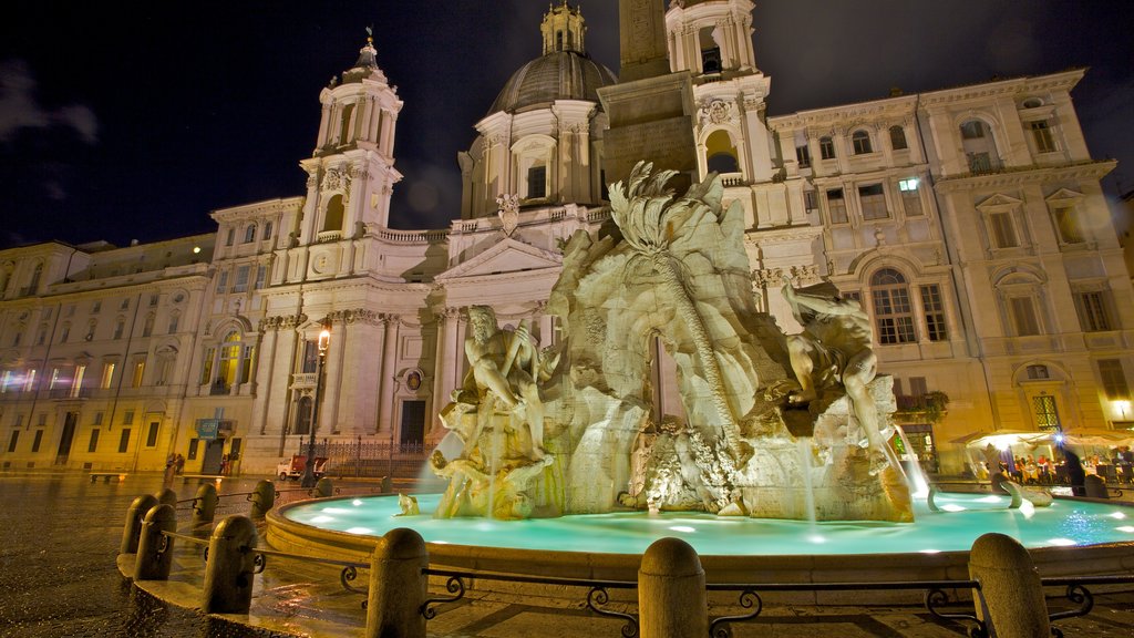 Piazza Navona which includes night scenes, a fountain and a square or plaza