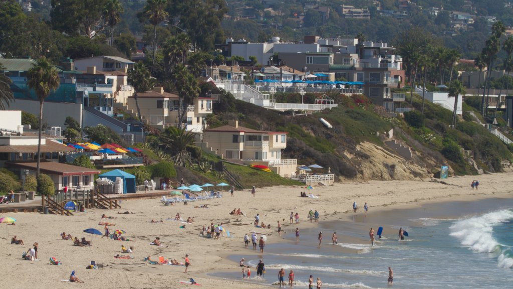 Laguna Beach showing landscape views, a sandy beach and a coastal town