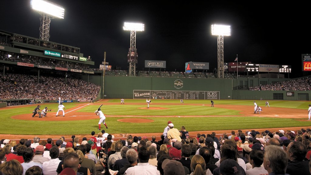 Fenway Park featuring a sporting event and night scenes as well as a large group of people