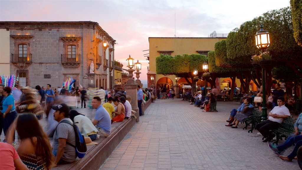 El Jardin showing a sunset as well as a small group of people