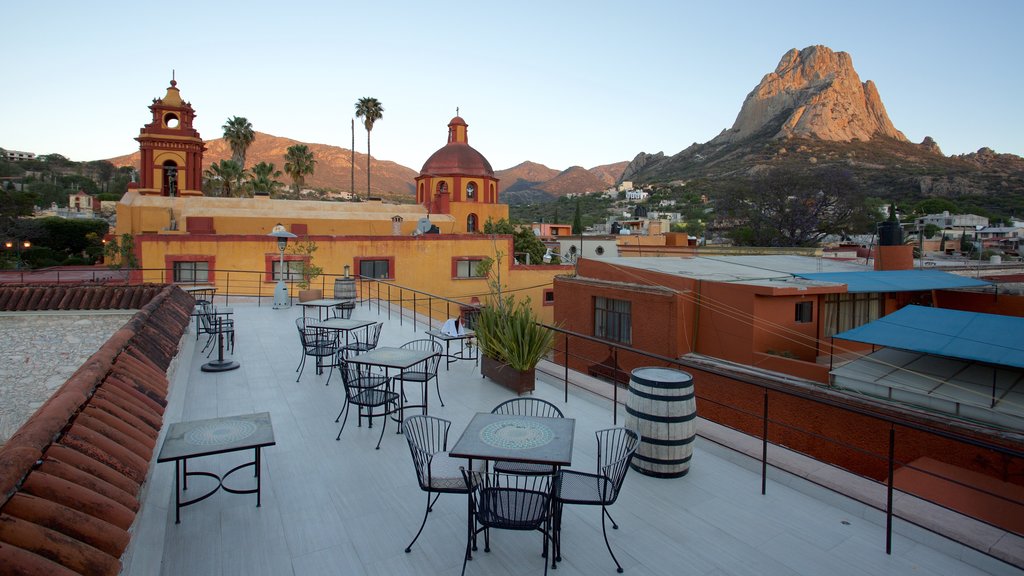 Pena de Bernal showing tranquil scenes, mountains and a small town or village