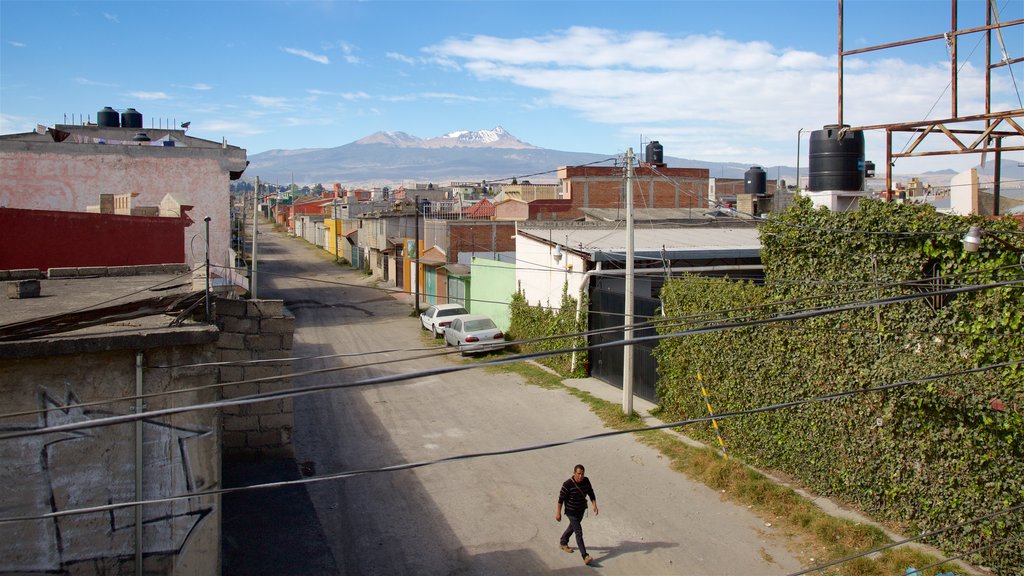 Nevado de Toluca National Park featuring a small town or village and landscape views as well as an individual male