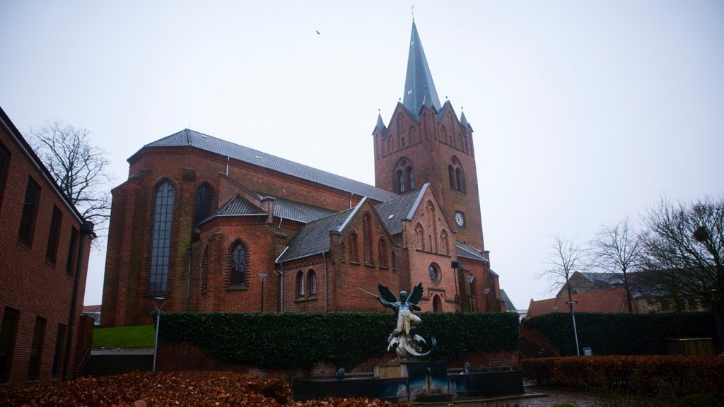 Slagelse showing a statue or sculpture and a church or cathedral