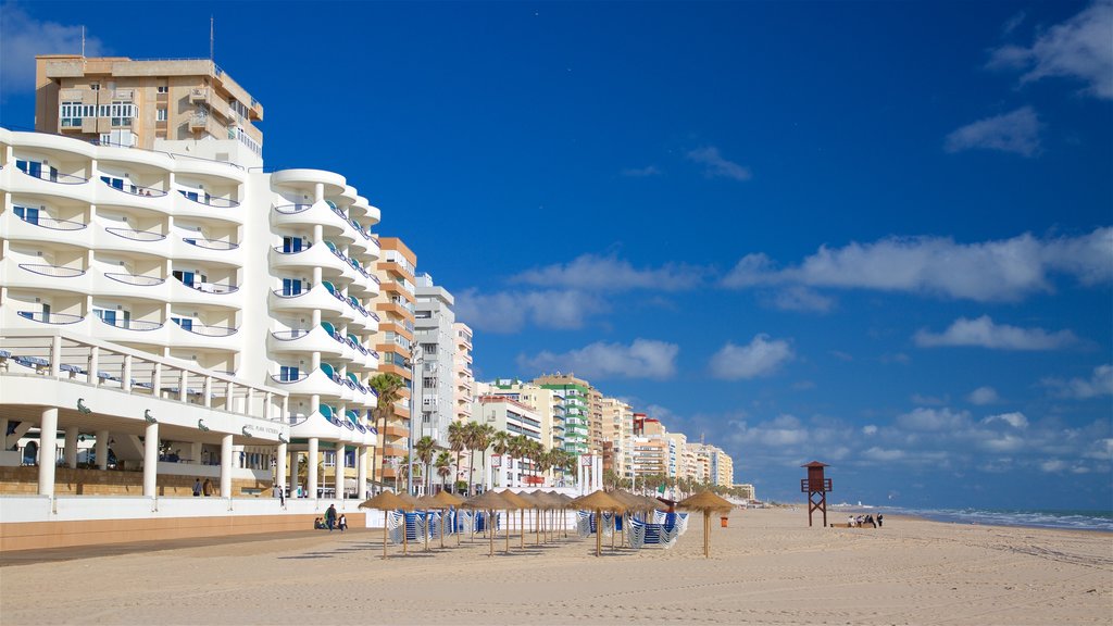 Victoria Beach which includes a coastal town and a sandy beach