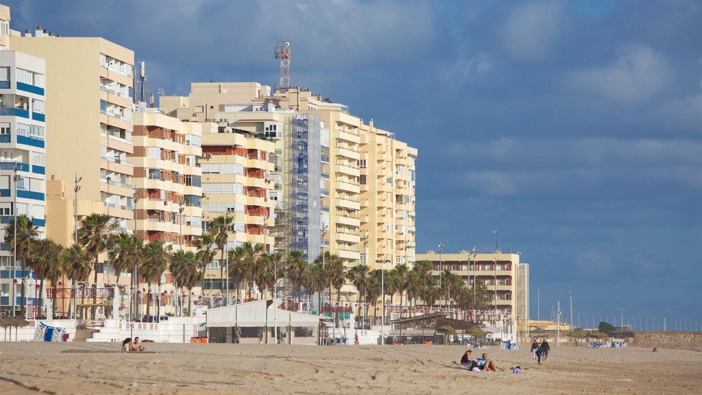 Playa de la Victoria which includes a beach and a coastal town