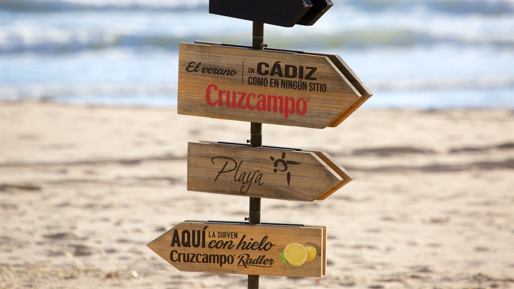 Victoria Beach showing signage and a sandy beach