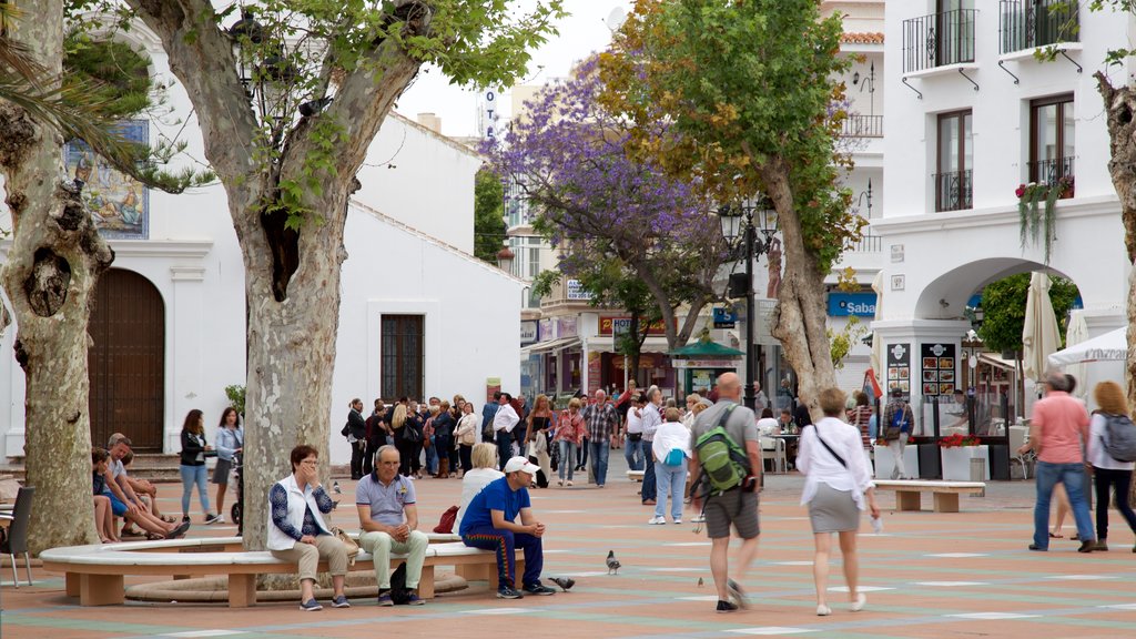 Balcon de Europa which includes a square or plaza as well as a large group of people