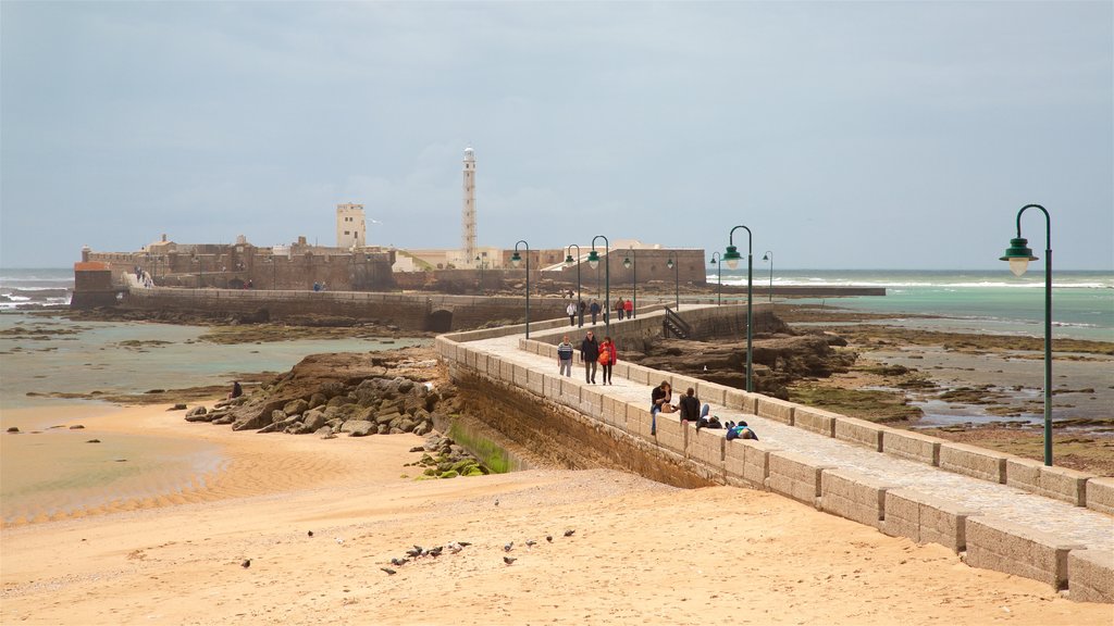 Fortress of San Sebastian which includes a sandy beach and château or palace