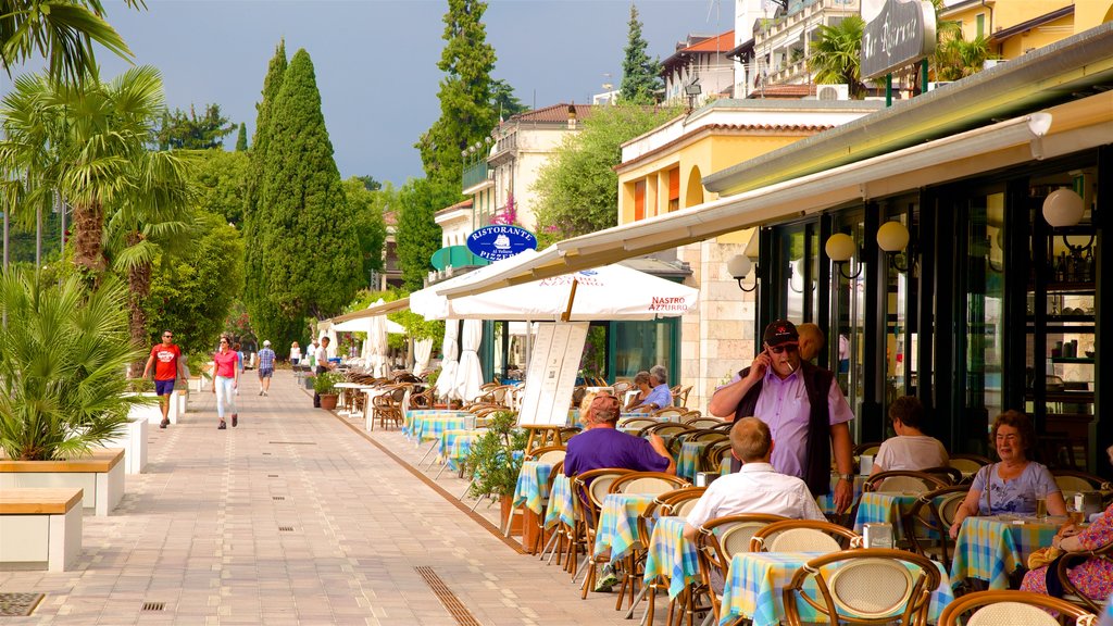 Gardone Riviera showing outdoor eating as well as a small group of people