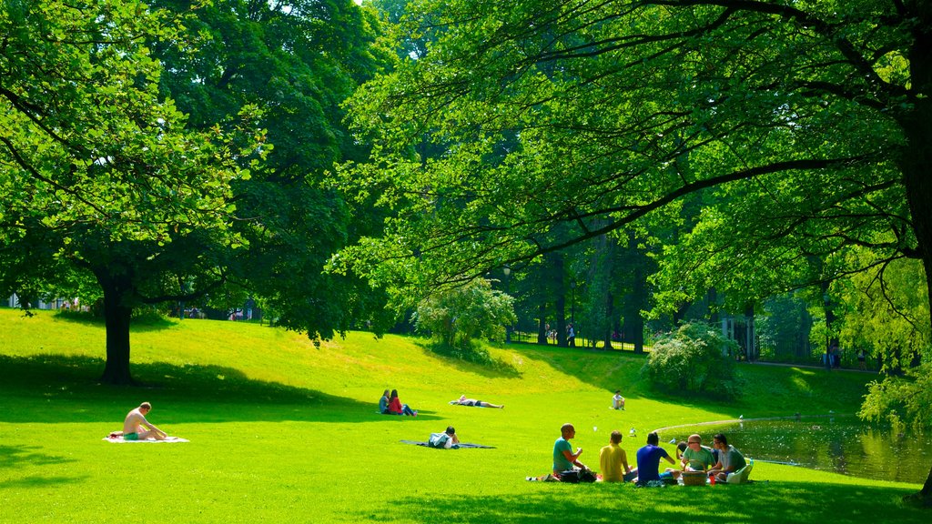 Palace Park featuring a garden and picnicing as well as a small group of people