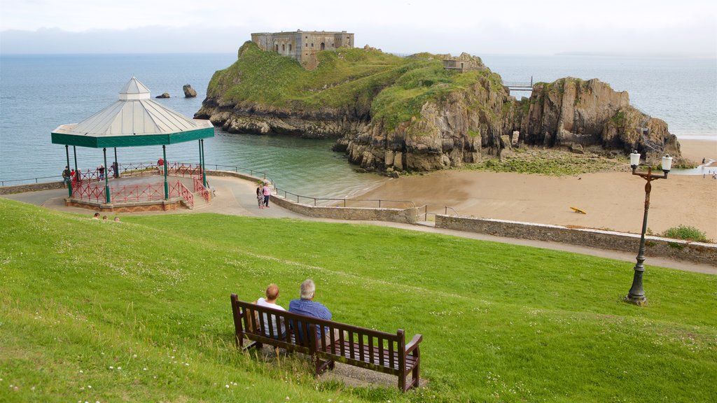 Tenby featuring a sandy beach, rugged coastline and views