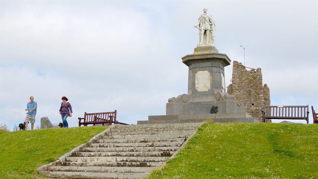 Tenby showing a statue or sculpture as well as a couple