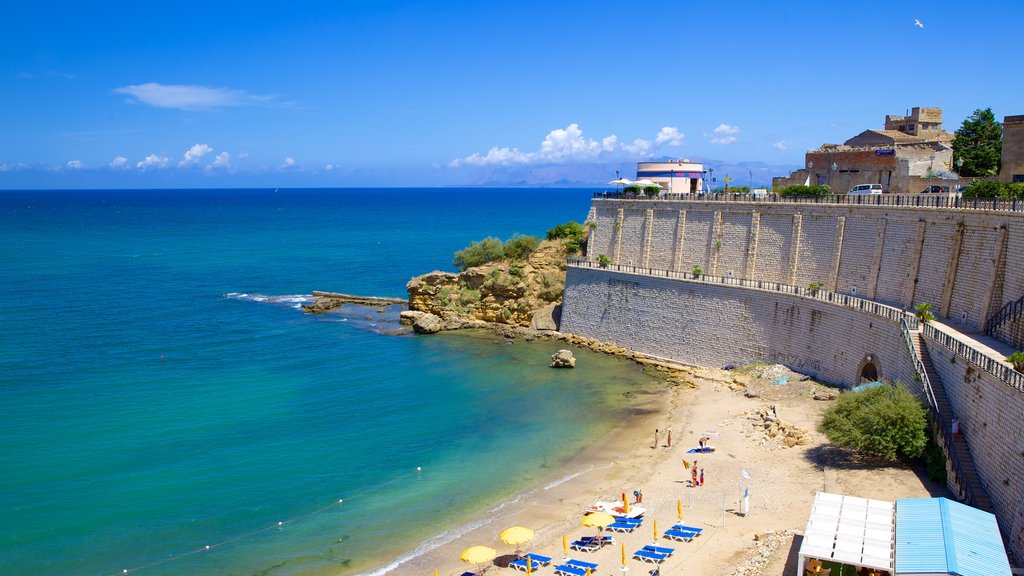 Castellammare del Golfo which includes tropical scenes, a sandy beach and rugged coastline