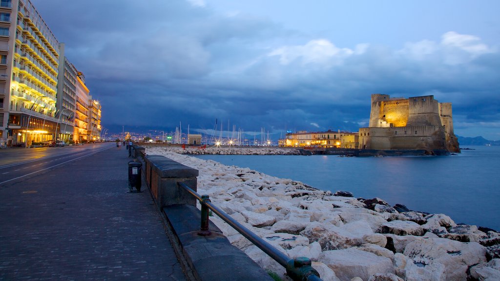 Castel dell\'Ovo which includes general coastal views, a castle and night scenes