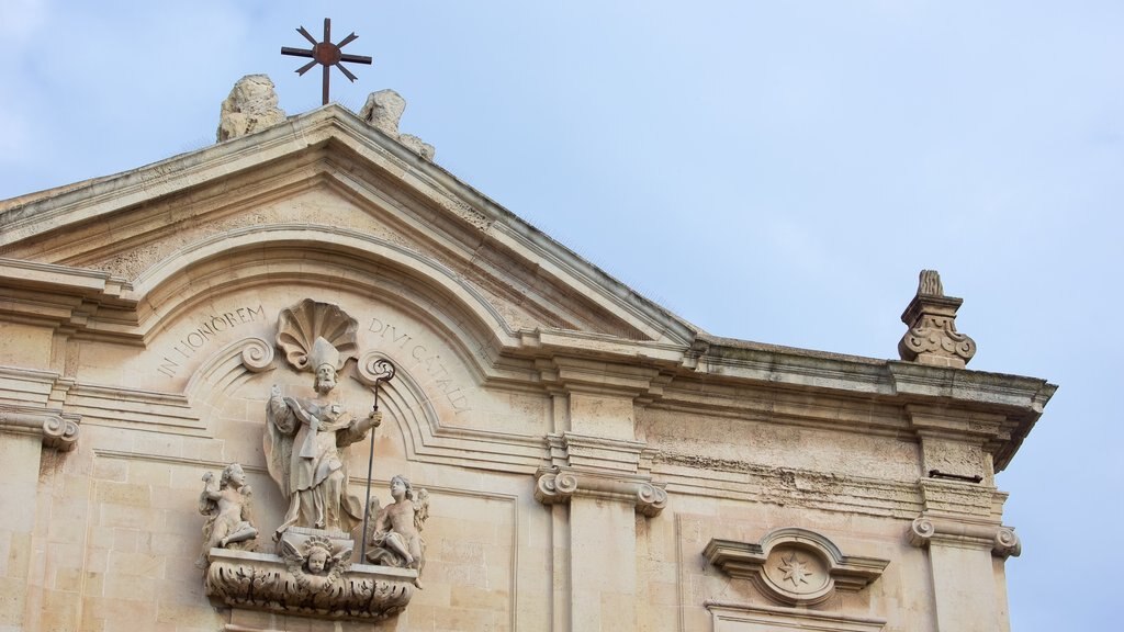 Taranto which includes a church or cathedral and religious elements