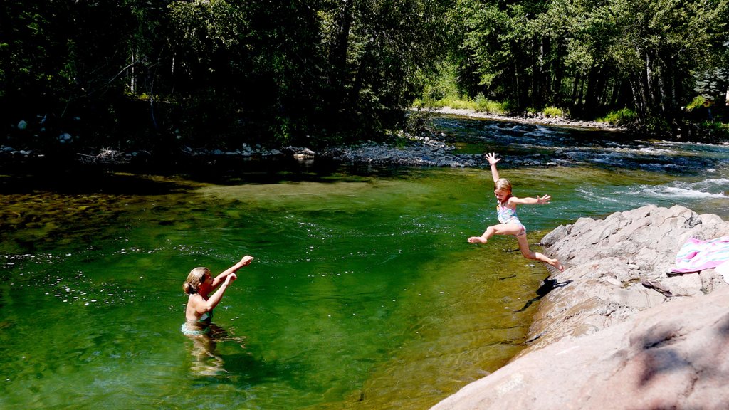 Sun Valley showing a river or creek and forest scenes as well as a family